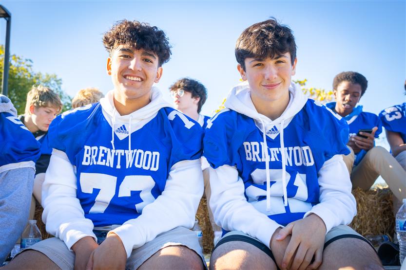 Two football players smile